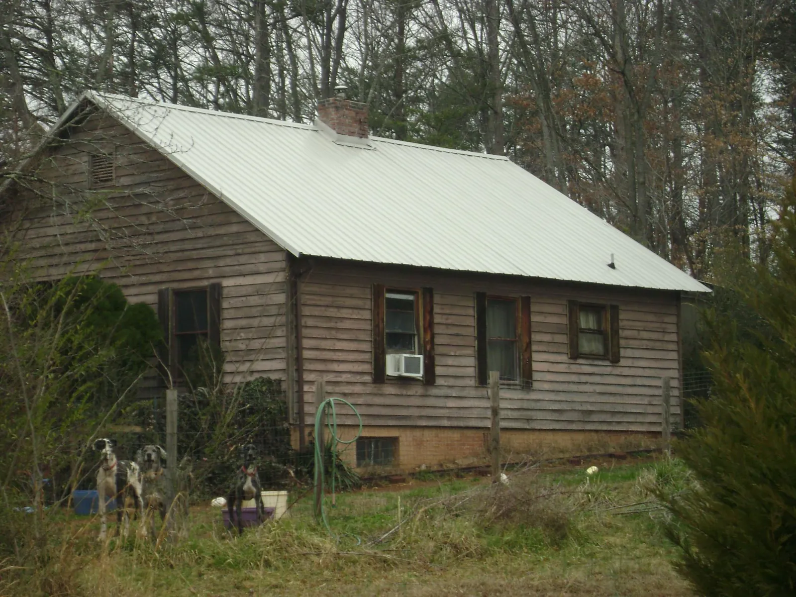 White metal roof on an old wood sided farmhouse, from a Metal Roof Installation job in Felt